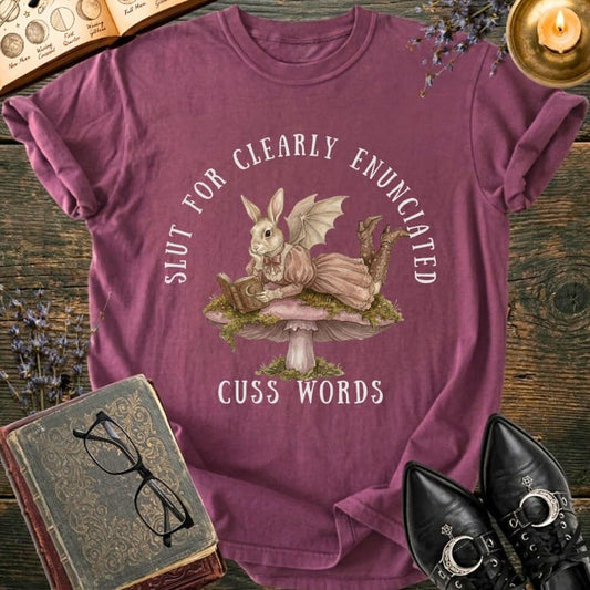 Bunny reading on mushroom with text "Slut for Clearly Enunciated Cuss Words".