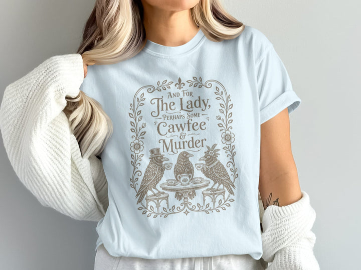 Light blue t-shirt with text "And for the Lady, Perhaps Some Cawfee & Murder."