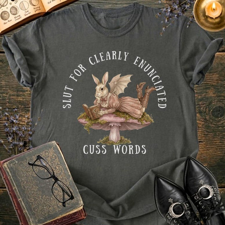 T-shirt with a bunny reading a book on a mushroom, text "SLUT FOR CLEARLY ENUNCIATED CUSS WORDS."