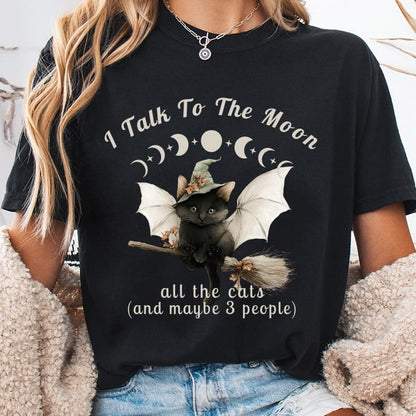 Black cat with witch hat flying on broom, "I Talk To The Moon" text.