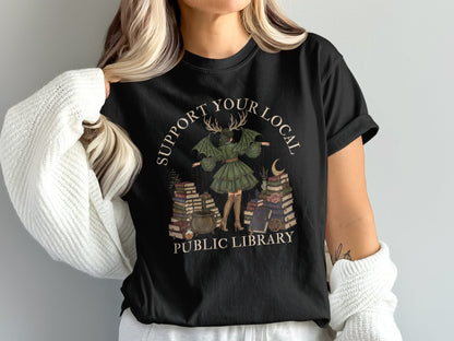 Black t-shirt with "Support Your Local Public Library" text and witch illustration.