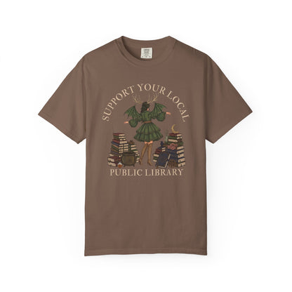 Brown t-shirt with "Support Your Local Public Library" text and fantasy art.
