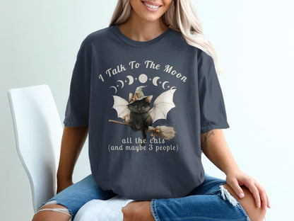 Black cat with wings on broomstick, "I Talk To The Moon" text.