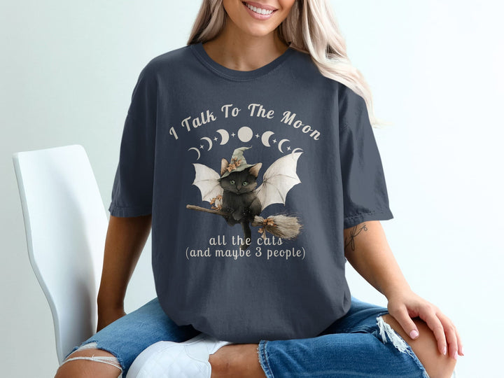 Black cat with wings on broomstick, "I Talk To The Moon" text.