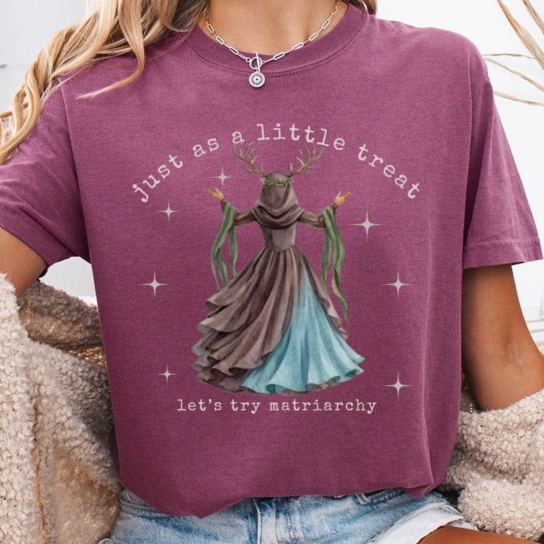 T-shirt with forest witch illustration and text "just as a little treat, let's try matriarchy".