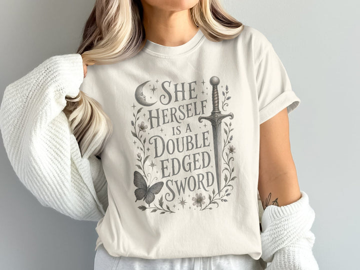 T-shirt with "She Herself Is A Double Edged Sword" text and sword graphic.