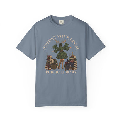 Graphic with witch and books, "Support Your Local Public Library."