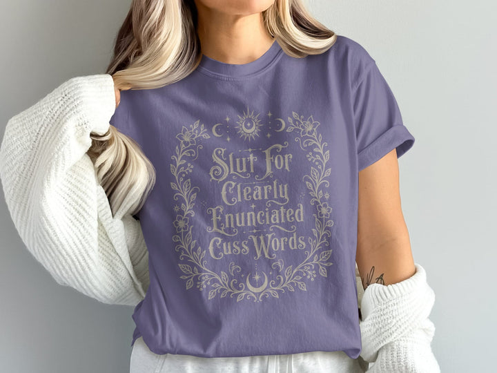 Purple t-shirt with ornate floral border and text "Slut For Clearly Enunciated Cuss Words."