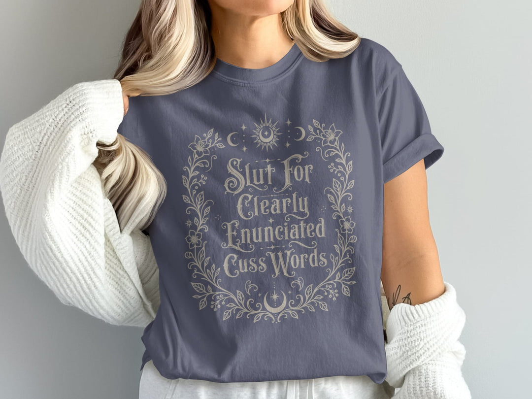 Grey t-shirt with a floral wreath graphic and text reading "Slut For Clearly Enunciated Cuss Words".