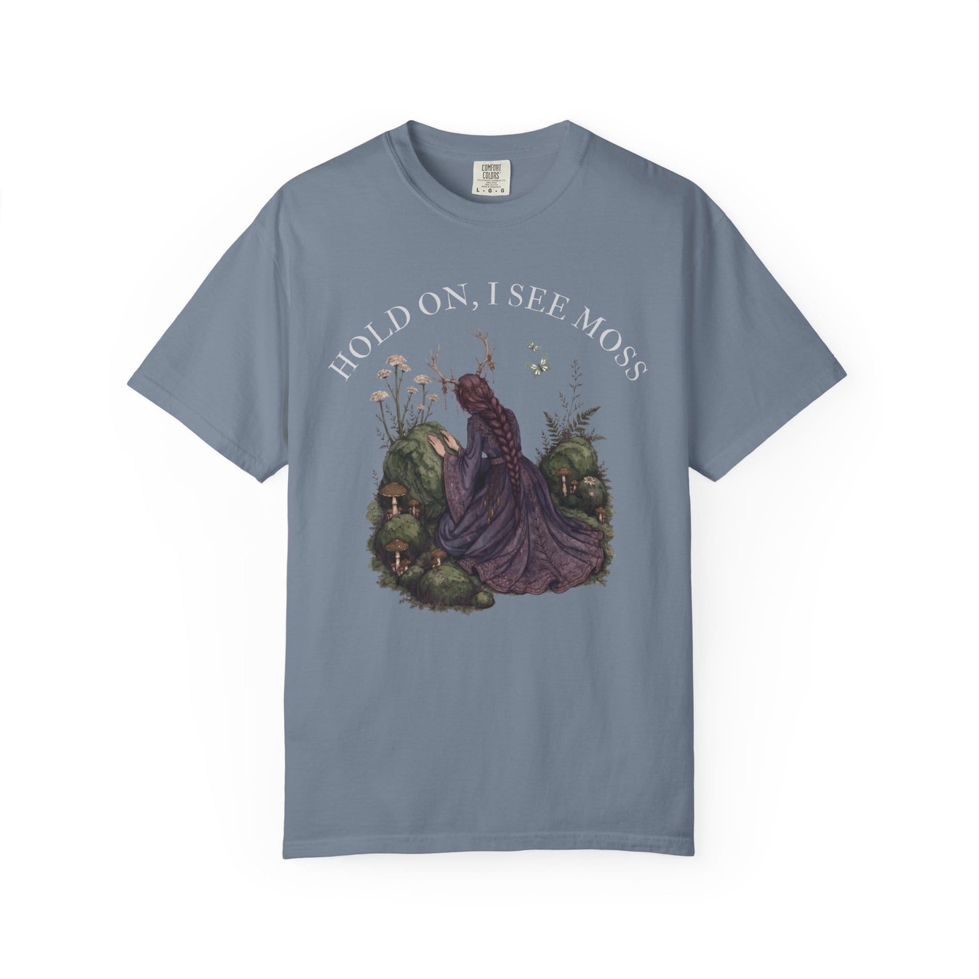 Woman in purple dress with mushrooms and butterflies, text "HOLD ON, I SEE MOSS".