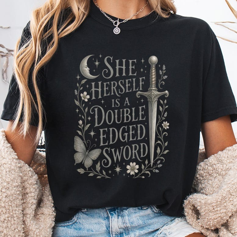 Black t-shirt with "She Herself Is a Double Edged Sword" text and illustration.