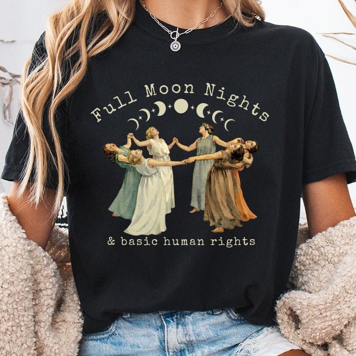 Black t-shirt with a circle of women dancing under a crescent moon and stars.