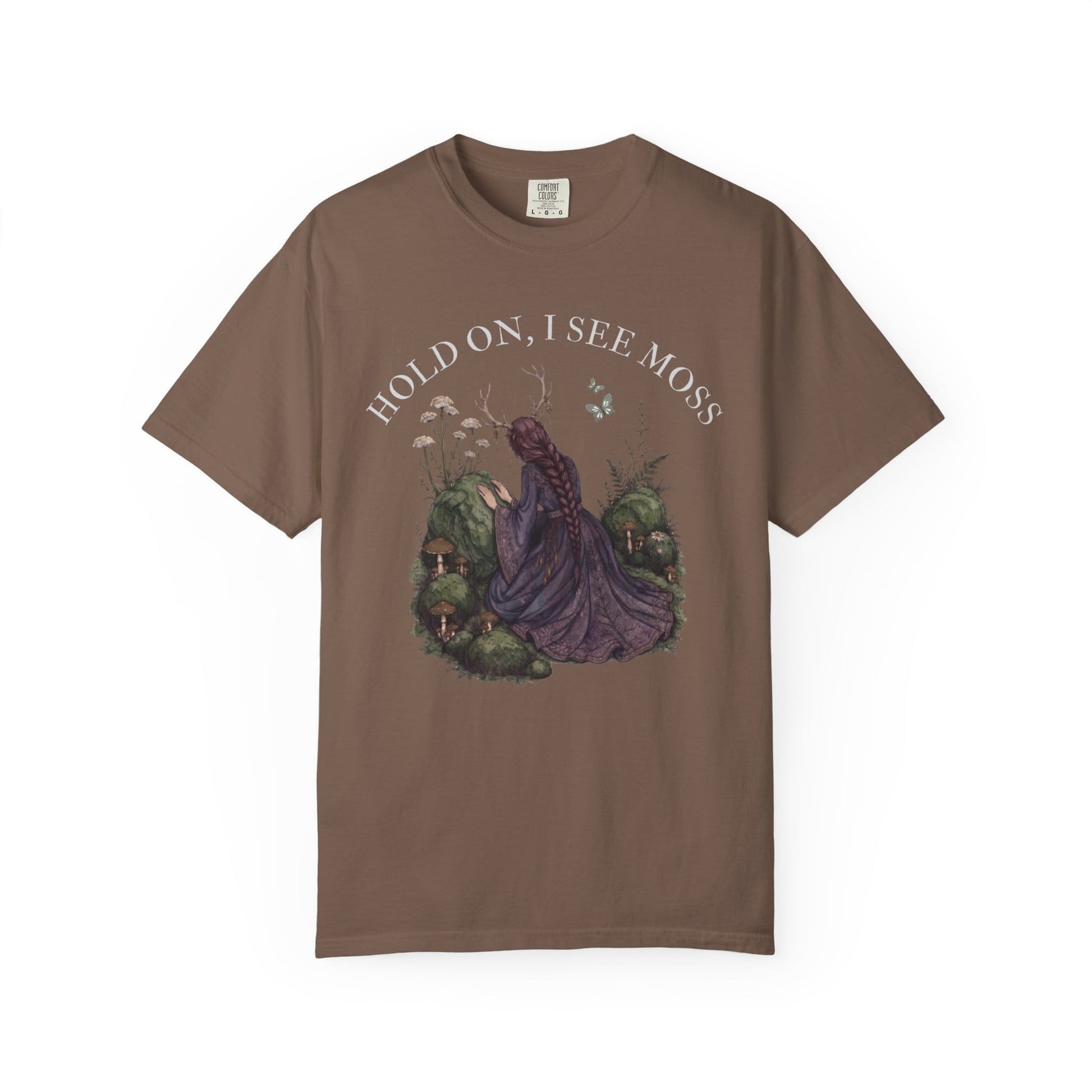 T-shirt with a woman in a purple dress and mossy forest scene illustration.