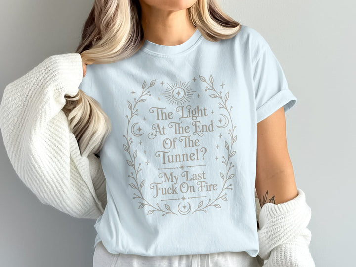 Light blue t-shirt with wreath design and text "The Light At The End Of The Tunnel? My Last Fuck On Fire".