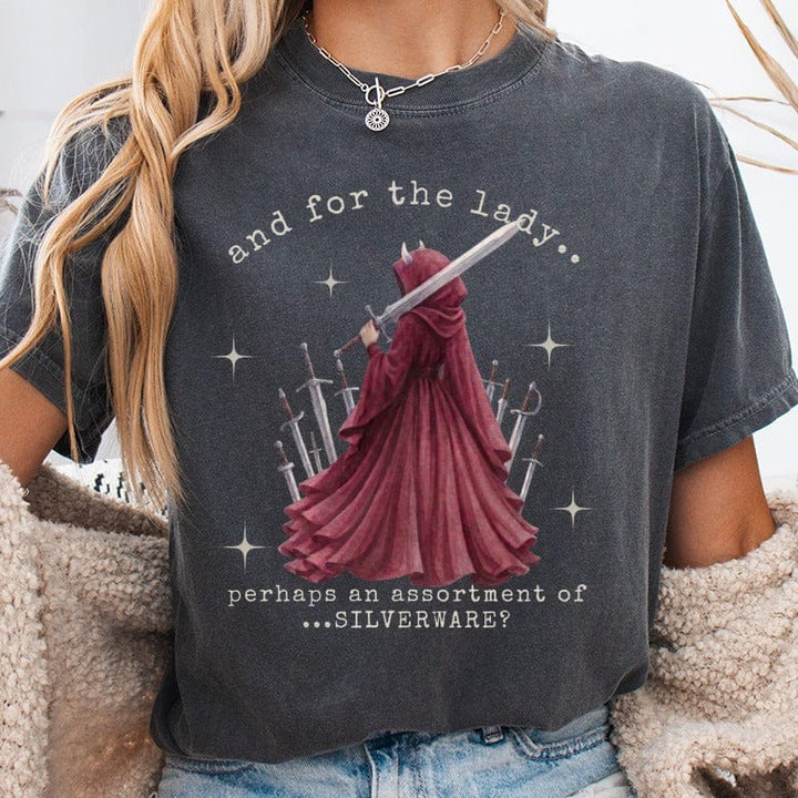 T-shirt with graphic of hooded figure surrounded by swords and text.