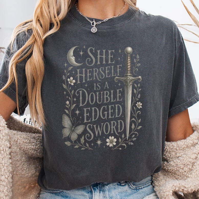 Dark gray t-shirt with "She Herself is a Double Edged Sword" text and sword illustration.