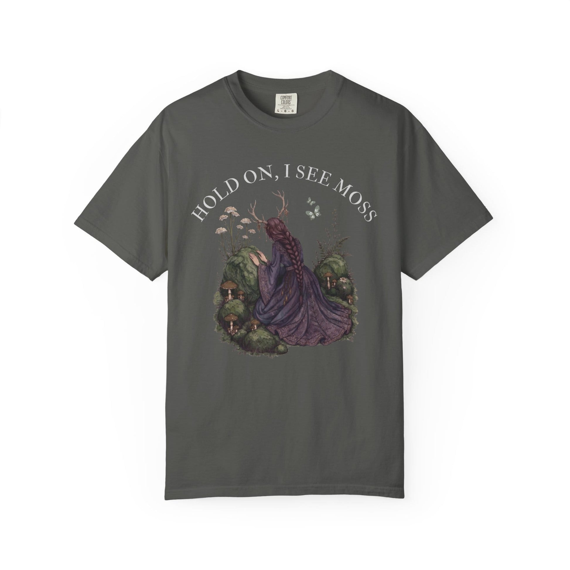 Woman in purple dress with antlers kneeling among moss and mushrooms.