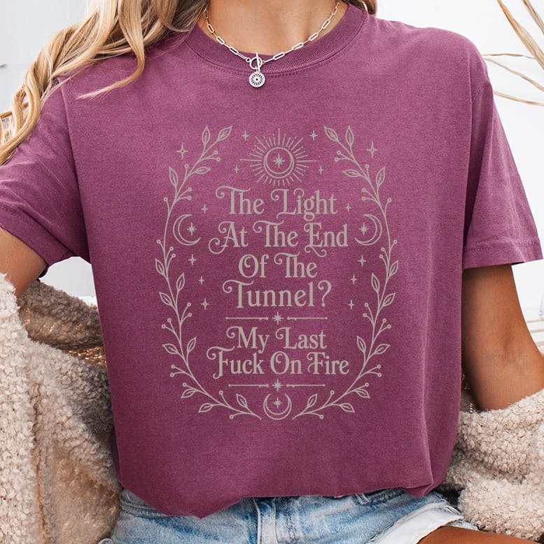 Maroon t-shirt with floral frame and text "The Light At The End Of The Tunnel? My Last Fuck On Fire".