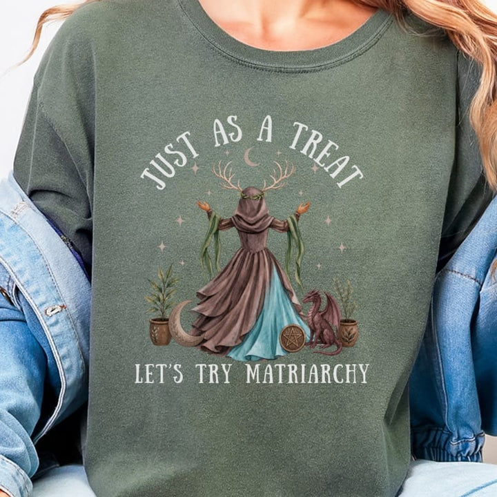 Green sweatshirt with mystical graphic and text "Just As A Treat, Let's Try Matriarchy".