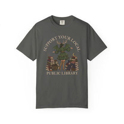 T-shirt graphic: winged figure holding books, labeled "Support Your Local Public Library".