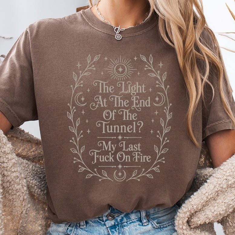 Brown t-shirt with "The Light At The End Of The Tunnel? My Last Fuck On Fire" text.