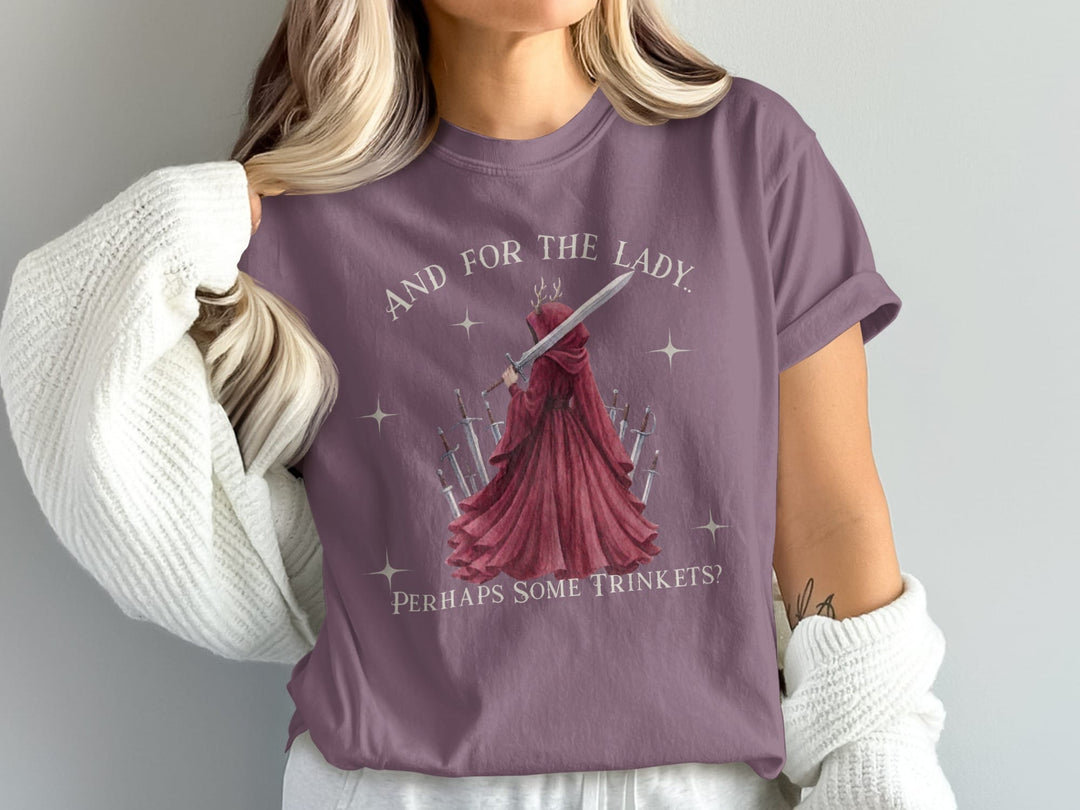 T-shirt with "And for the lady, perhaps some trinkets?" text and a cloaked figure with a sword.