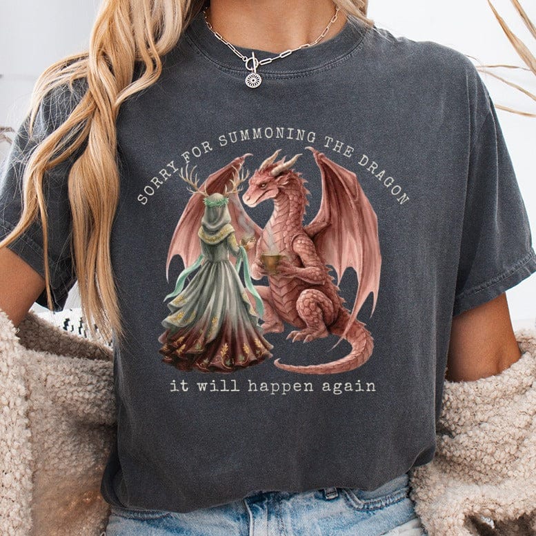 Woman wearing t-shirt with dragon and text: "Sorry for summoning the dragon it will happen again."