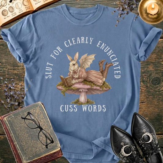T-shirt with bat-winged bunny reading on a mushroom, text "Slut for Clearly Enunciated Cuss Words".