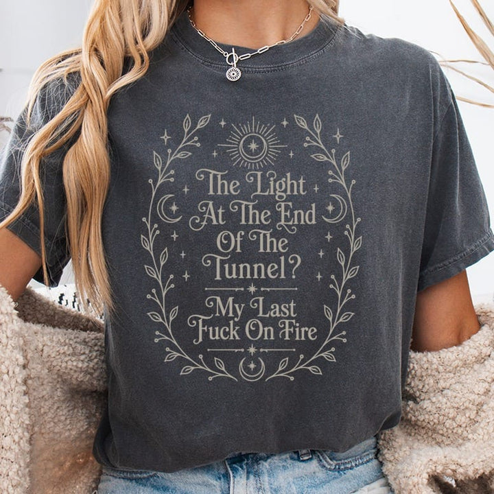 Dark grey t-shirt with celestial border and text "The Light At The End Of The Tunnel? My Last Fuck On Fire".