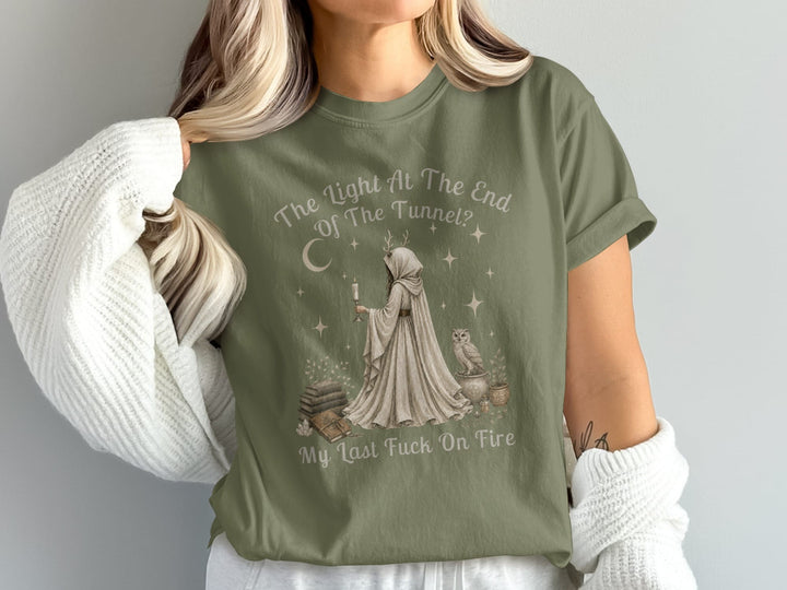 T-shirt with witch illustration, candle, books, owl, and text "The Light At The End Of The Tunnel? My Last Fuck On Fire".