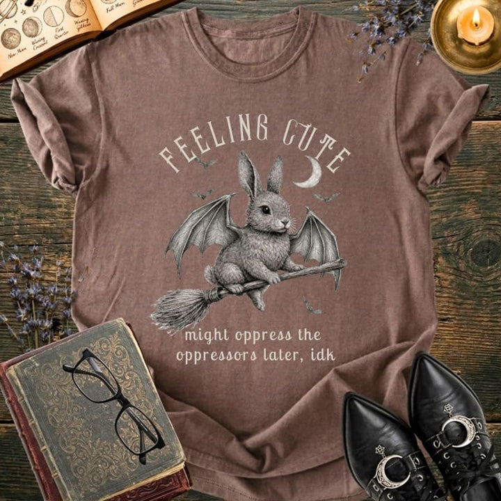 Brown t-shirt with a bunny riding a broom, "Feeling Cute" and a quote.