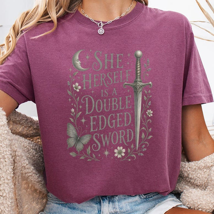 T-shirt with "She Herself Is A Double Edged Sword" text, sword, moon, and butterfly graphic.