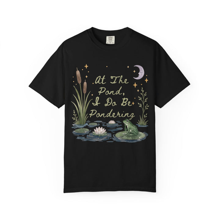 Black t-shirt with watercolor art of a frog, lily pads, cattails, and moon.