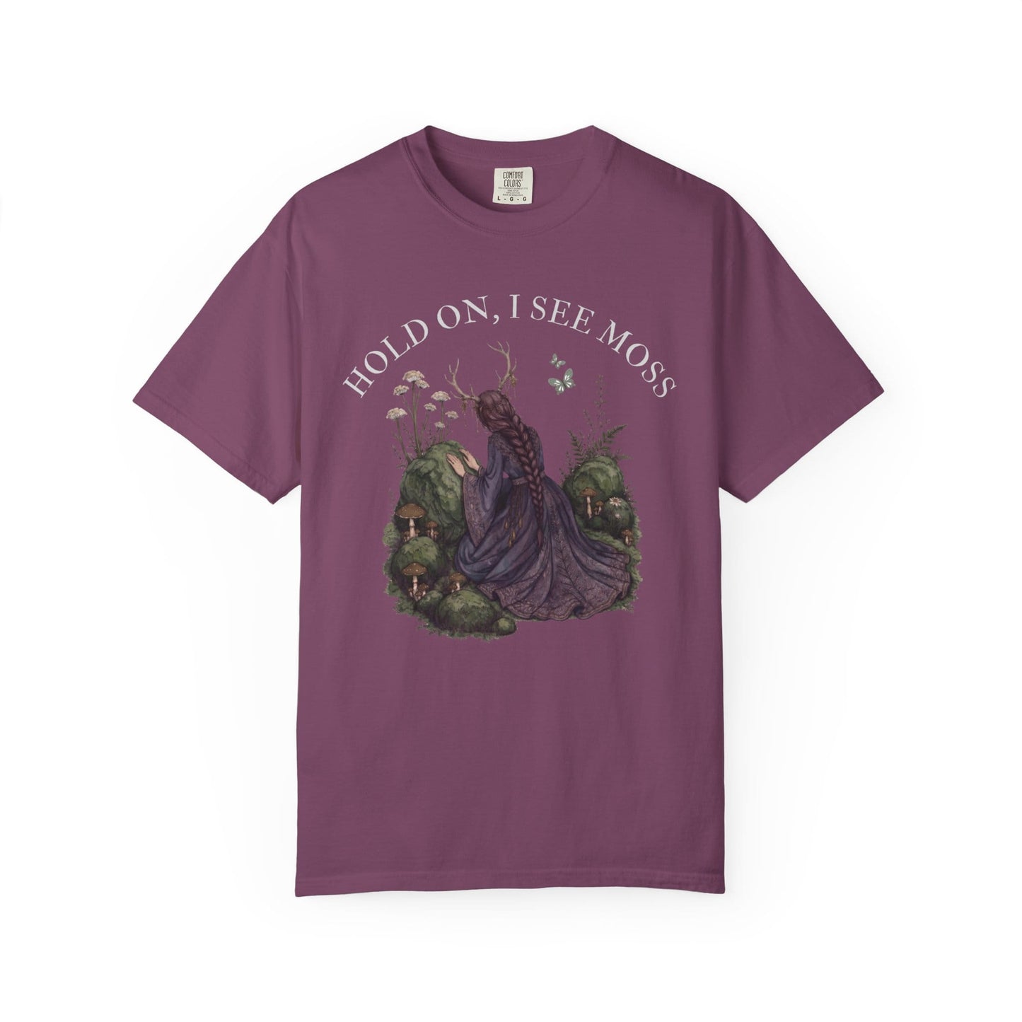 Purple t-shirt with "Hold On, I See Moss" graphic of a woman in a forest.