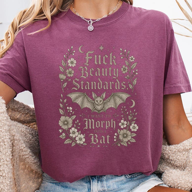 Berry t-shirt with "Fuck Beauty Standards, I Want to Morph Into a Bat" text and bat graphic.