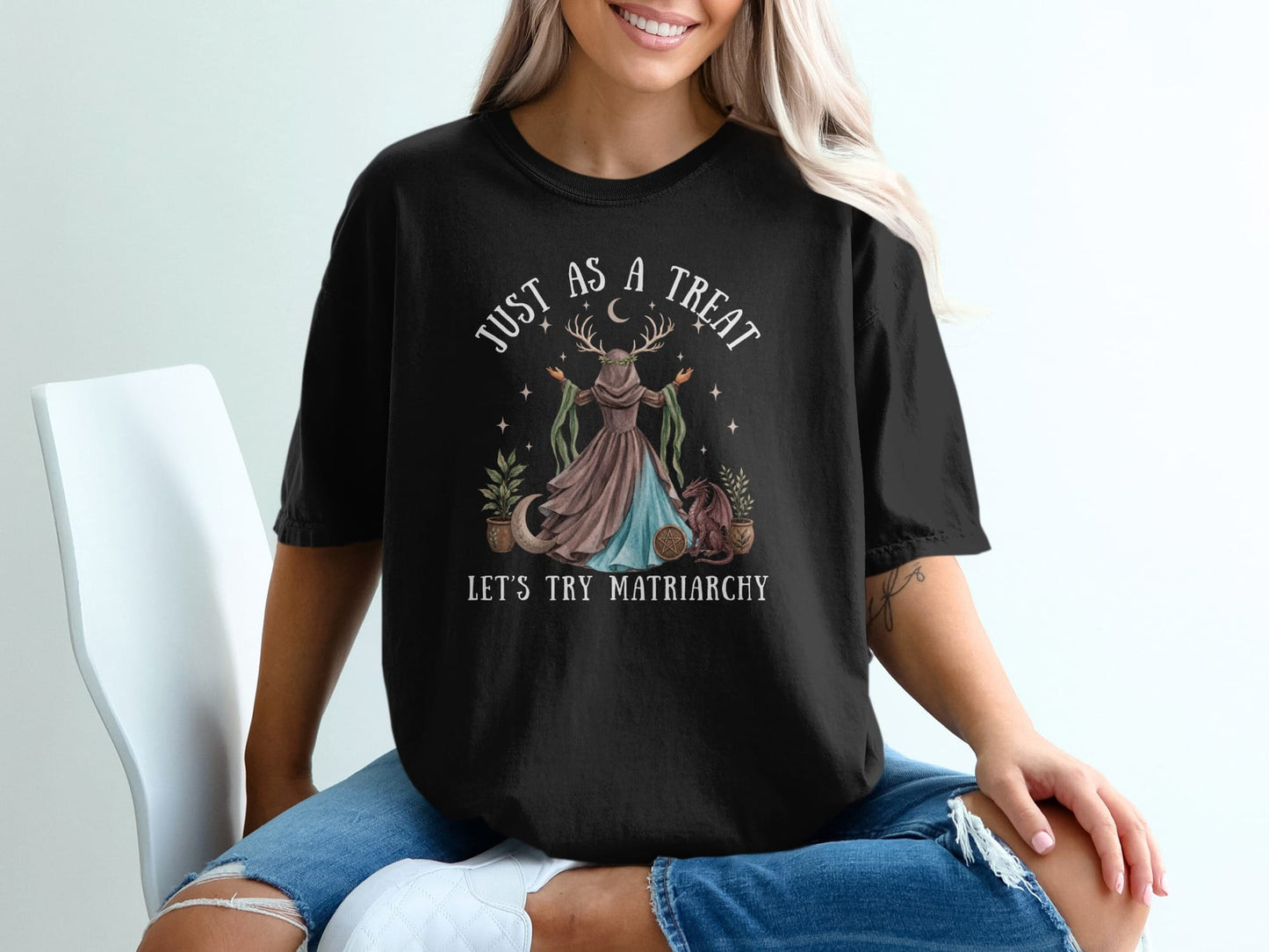 Black t-shirt with "Just As a Treat Let's Try Matriarchy" text and moon goddess graphic.