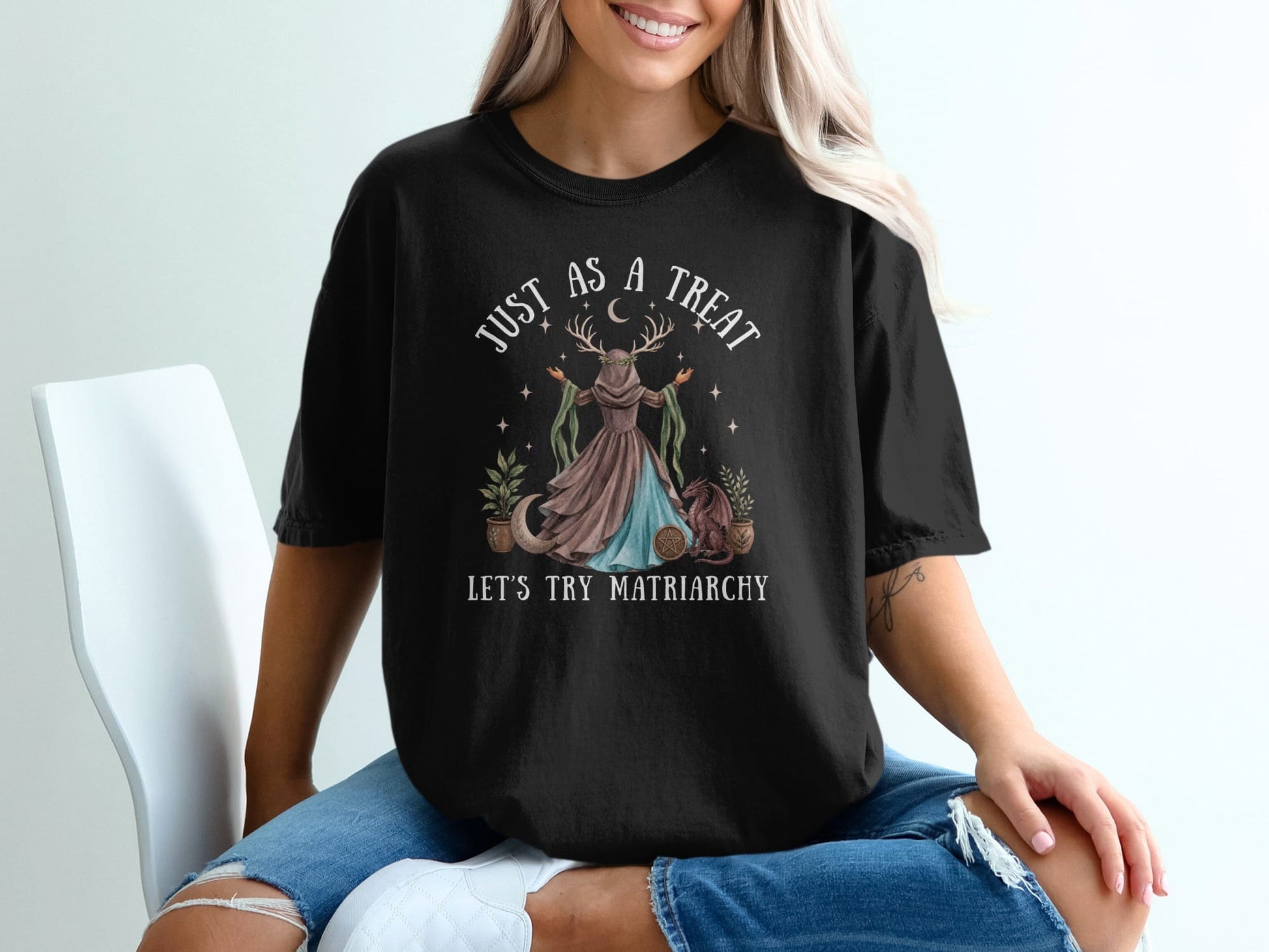 Black t-shirt with "Just As a Treat Let's Try Matriarchy" text and moon goddess graphic.